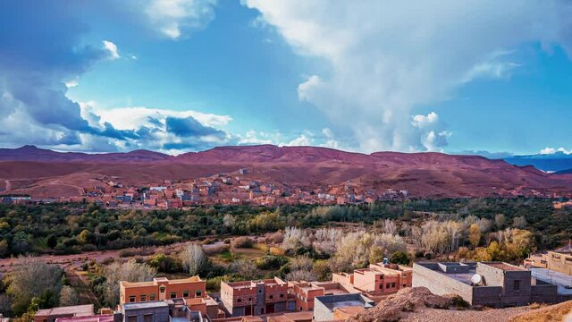 Aerial timelapse view of the beautiful old town in Morocco. Colorful houses by the mountains. Magical Morocco traditional village.