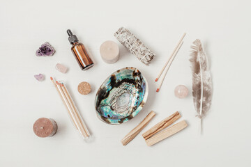 Fototapeta na wymiar Smudge kit with white sage, palo santo, abalone sea shell. Natural elements for cleansing environment from negative energy, adding positive vibes. Spriritual practices, witchcraft concept