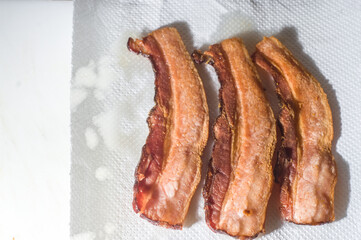 bacon, sliced ​​and fried and placed on a napkin to drain the oil