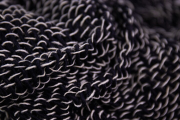 Black and White Handicraft Clothes on White Background .
Close up Detail of Hand Woven Cotton Scarf ,
Design texture and Pattern by Artisans in Northern Villages of Thailand