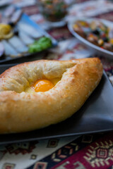 Adjarian khachapuri dish of Georgian cuisine from dough with egg yolk