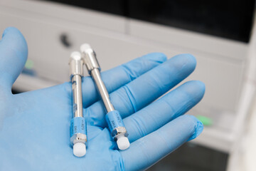 Small HPLC 50 mm columns for separation compounds in laboratory worker hand in rubber glove. Fast high performance liquid chromatography analysis in chemical and microbiological laboratory. Clinical