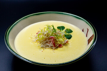 pumpkin cream soup on black background
