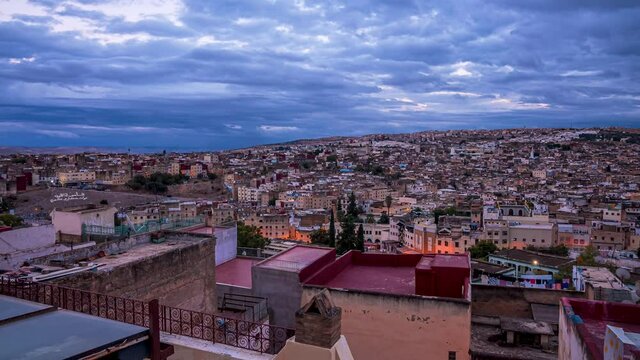 Beautiful timelapse of the Fes city in Morocco. Aerial view of the sunset city from above. Day to night transition.