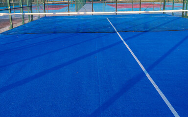Blue paddle tennis court field with white lines. Healthy sports concept