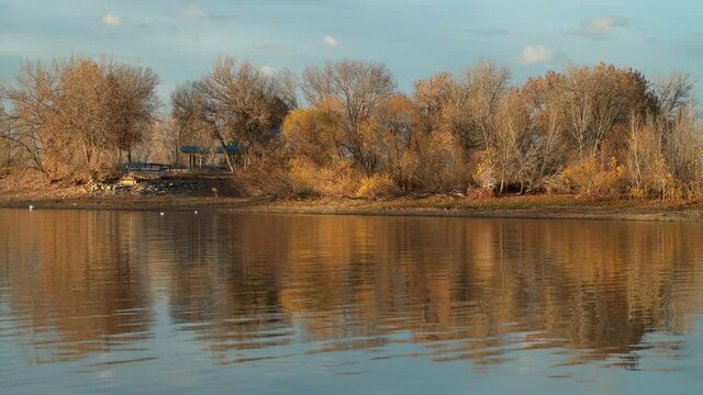sunset light on a calm lake in November scenery - picnic area in Boyd Lake State Park in northern Colorado