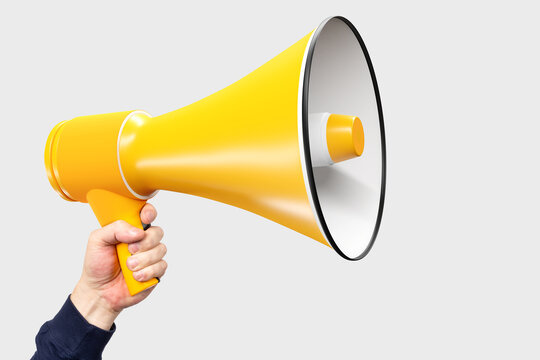 Man is holding big loudspeaker. Yellow megophone in man's hand. Loudspeaker stands for advertising and PR. Hand with bright gramophone on white background. Concept - advertising promotion