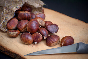 chestnuts out of the pouch on wooden floor