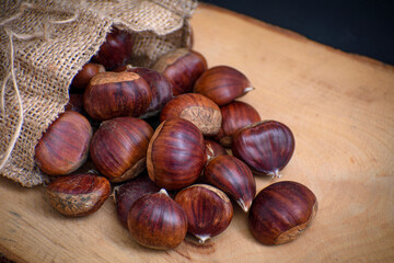 chestnuts out of the pouch on wooden floor