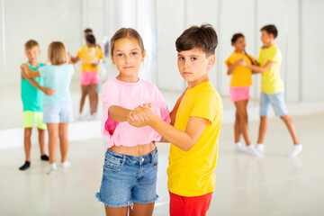 Pairs of boys and girls dancing waltz during rehearsal.