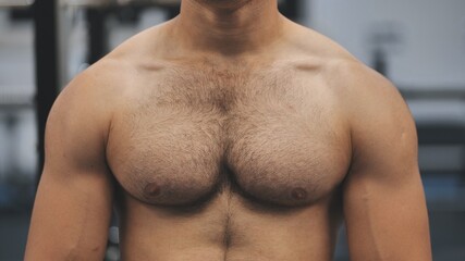 A man moves his strong and muscular chest