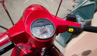 speedometer gauge on red motor scooter