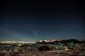 Fototapeta na wymiar Icebergs in the Jokulsarlon lake in Vatnajokull National Park by night, Iceland