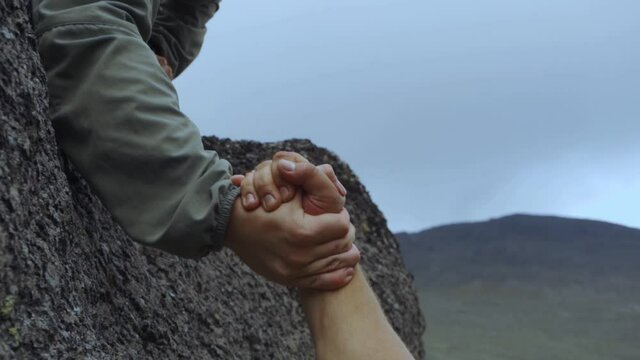 Mutual assistance. Hands on the background of mountains. Help people. Support and mutual assistance