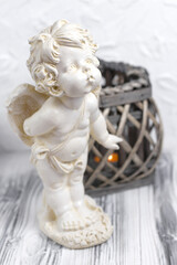 Vintage baby angel figurine. Little cupid statue. Interior statues for decorating the living room and home. Vertical orientation.