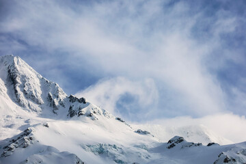 Fototapeta na wymiar snow covered mountains with interesting cloud