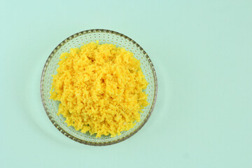 Cooked Yellow Rice in a Plate, Portion of Steamed Yellow Rice (Nasi Kuning) with Turmeric, Copy Space for Text