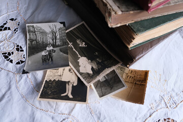 old photo albums lie on a white mint tablecloth, vintage photographs of 1950, concept of family tree, genealogy, childhood memories, connection with ancestors