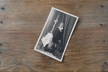 old vintage monochrome photograph in sepia color is scattered on a wooden table, the concept of...