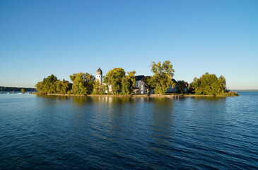 scenic Frauenwoerth abbey on green island Frauenchiemsee or Fraueninsel in Bavaria (Germany)	