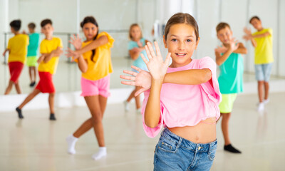 Children exercising modern dance moves together during their group classes.