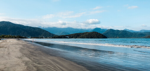 Fototapeta na wymiar Tropical beach with dark sands due to oil