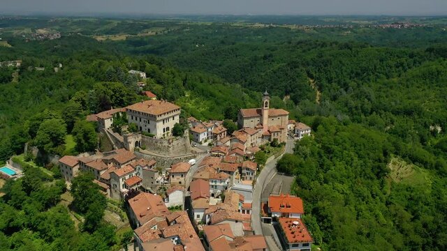 Aerial drone view overlooking the Montaldeo castle and town, in Piedmont, Italy