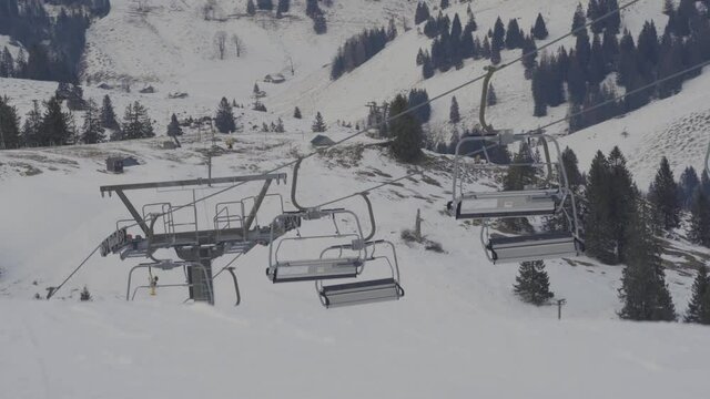 Handheld shot of empty ski lifts during COVID 19 Pandemic where nobody was allowed to go skiing during the season.