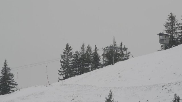 Handheld shot of empty ski lifts during COVID 19 Pandemic where nobody was allowed to go skiing during the season from further away