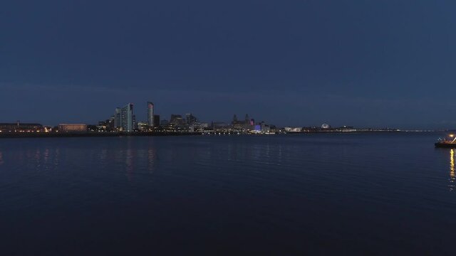 River Mersey, River of Light, Liverpool, England. Night time. Drone flys forward. 4k