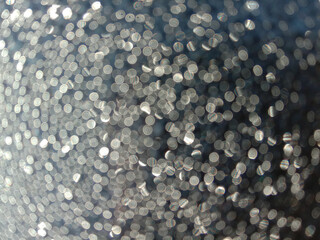 Shiny bokeh balls closeup, defocus photo of dew drops in sunlight