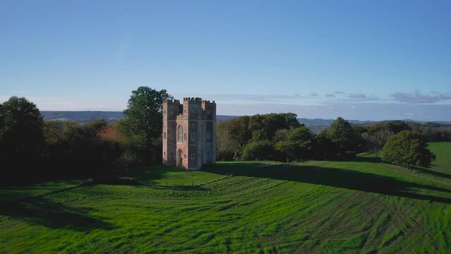 The Belvedere Tower over Powderham Park from a drone in Autumn Colors, Powderham Castle, Exeter, Devon, England