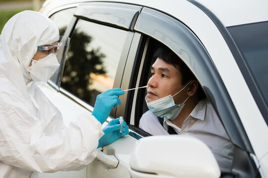 Doctor In PPE Suit Test Coronavirus(covid-19) To Man In Car By Nasal Swab Cotton, Drive Thru Test