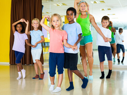 Positive little boys and girls dancing pair dance in the ballet studio. High quality photo