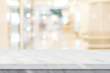 Empty white table top, counter, desk over blur store with bokeh background, White marble stone table, shelf and blurred shop for food, product display mockup, 