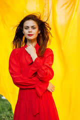pretty woman in red dress nature yellow cloth on background