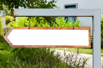 Empty wooden signpost at a walkway inside the park