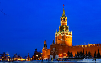 Fototapeta na wymiar Night view of Spasskaya Tower of the Moscow Kremlin and wall of the Kremlin with illumination and streetlights