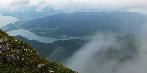 Panoranic overview on lake Wolfgangsee in Salzkammergut austria europe in rainy day on the shore covered mist