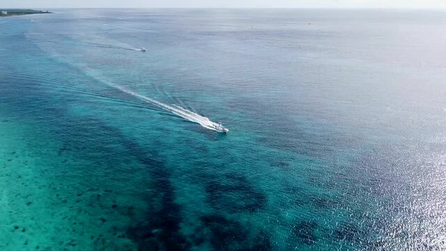 Aerial View of a Small Boat Creating a Wake in the Caribbean Sea