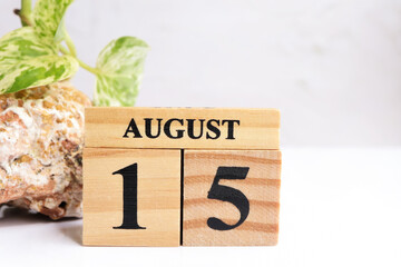 Hello August, Cube wooden calendar showing date on 15 August. Wooden calendar with date on the table.