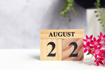 Hello August, Cube wooden calendar showing date on 22 August. Wooden calendar with date on a light...