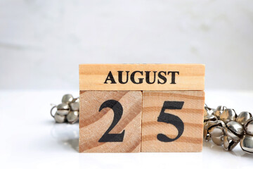 Hello August, Cube wooden calendar showing date on 25 August. Wooden calendar with date on a light...