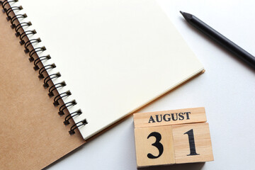 Hello August, Cube wooden calendar showing date on 31 August. Wooden calendar with date on a light background.
