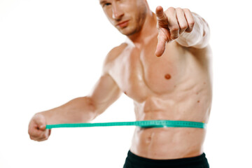 Obraz premium athletic man with measuring tape muscle workout