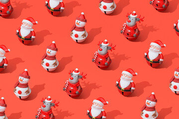 Pattern composition of Christmas toys on red background with hard shadows