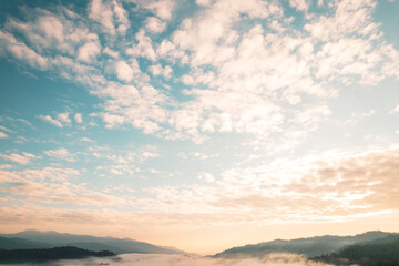 Fototapeta na wymiar Flying above the clouds sunrise and fog