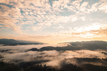 Flying above the clouds sunrise and fog