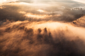 Flying above the clouds sunrise and fog