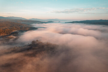 Flying above the clouds sunrise and fog